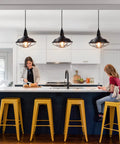 Black Pendant Light Set 3 Pack, Industrial Farmhouse Pendant Lighting over kitchen island with yellow stools and family.