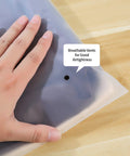 Hand holding a frosted bag with vent, part of 20 Pcs Travel Storage Bags Set For Clothes Cosmetics Shoes Reusable Frosted Ziplock Pouches.