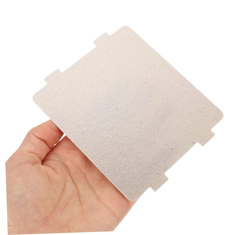 Hand holding a microwave waveguide mica sheet, part of 10 Pcs Microwave Waveguide Cover Mica Insulation Sheets Replacement Parts For Ovens Heat Resistant.