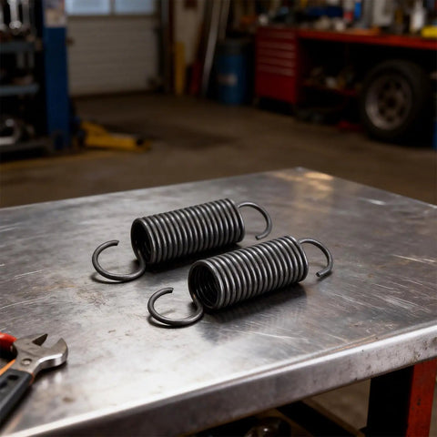 Pair Of Heavy Duty Steel Recliner Springs Featuring Half Inch Tension Coils on a workbench, ideal for furniture fixes.
