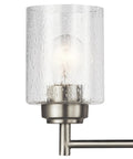 Close-up of clear seeded glass light on Winslow 30 Inch Vanity Light In Brushed Nickel Four Light Clear Seeded Glass Bath Fixture.
