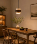 Axamate Wabi Sabi Pendant Light Natural Stone Chandeliers Dia 8" hanging above a wooden dining table with foliage.