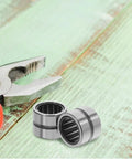 2 Piece Needle Roller Bearing Kit Fits Electric Hammer Drill And Angle Grinder Precision Steel Thrust Bearings installed beside pliers