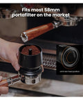Three Piece Sleek Espresso Powder Receiver Cup And Dosing Funnel Fits 51 54 58Mm Portafilters with ground coffee in hand.
