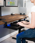 Under Desk Keyboard Tray With Pull Out Platform Extra Sturdy C Clamp Mount Big 33 Inch Wide By 11 Inch Deep Slide Out Tray Built In Pencil Drawer Space Saving Keyboard And Mouse Setup Black, person using at a desk