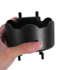 Hand holding Black Plastic Aerosol Can Holder Wall Mount Organizer for Spray Bottles and Cans close-up view.