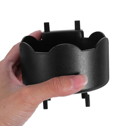 Hand holding Black Plastic Aerosol Can Holder Wall Mount Organizer for Spray Bottles and Cans close-up view.
