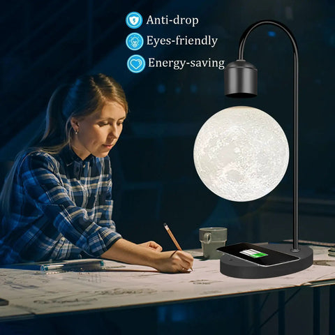 Woman working beside Magnetic Levitating Moon Lamp With Built In Wireless Charging Pad Zero Gravity Floating Desk Light