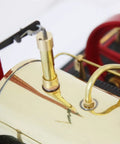 Close-up of D21 Steam Engine Model With Esbit Dry Fuel Burner TÜV Certified showing red wheel and brass details.