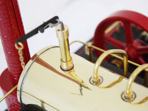Close-up of D21 Steam Engine Model With Esbit Dry Fuel Burner TÜV Certified showing red wheel and brass details.