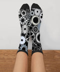 Person wearing Gearhead Engineering Crew Socks for Men and Women Funny Mechanical Novelty Footwear Unisex One Size Fits Most 98 Polyester 2 Spandex Soft Durable Knit Fits Mens 7.5 to 12 Womens 5.5 to 10 Great Gift Idea for Engineers and Tech Fans featuring mechanical gear pattern in black, white, and gray.