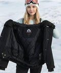 Woman showcasing inner lining of Women's Waterproof Ski Jacket With Windproof Dope Warmth Snowboard Style Snow Coat.