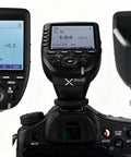 Sony TTL Wireless Flash Transmitter With XPro-S Upgrade, large LCD screen and slanted design, mounted on camera, front view.