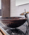 USZWBY Artistic Vessel Sink Bathroom Tempered Glass Vanity Sink, Round Bowl and Waterfall Faucet Chrome on marble countertop.