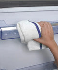 Hand using 100% cotton terry cloth from Value Pack Of 36 Absorbent 16x19 Inch Terry Cloth Cleaning Rags For Home And Business on appliance