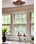 Dope Tiffany Style 16 Inch Flush Mount Ceiling Light With Dragonfly Pattern in a kitchen setting with greenery
