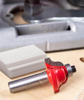 Two Pack Pro Grade 45 Degree Lock Miter Router Bit Setup Jigs For One Half Inch And Three Quarters Inch Stock With Three Quarters Inch And Five Eighths Inch Cutting Height Crown Molding Jig For Miter Saw, showing a red lock miter router bit and HDPE jig on wood surface.