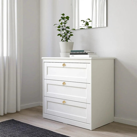Six Piece Ginkgo Leaf Cabinet Knobs And Solid Zinc Drawer Pulls In Rustproof Brushed Gold Finish on white dresser with plant.