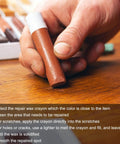 Person holding a brown repair wax crayon from the Dead On Color 20 Piece Furniture Repair Wax Crayons Kit for fixing scratches.