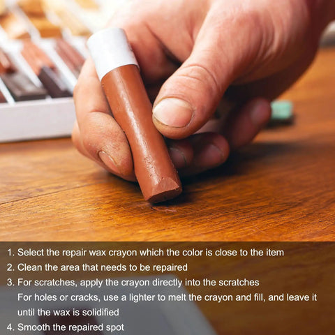 Person holding a brown repair wax crayon from the Dead On Color 20 Piece Furniture Repair Wax Crayons Kit for fixing scratches.