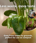 Person using a coffee grounds dispenser to apply coffee grounds to a plant in a yellow pot, highlighting compost use.