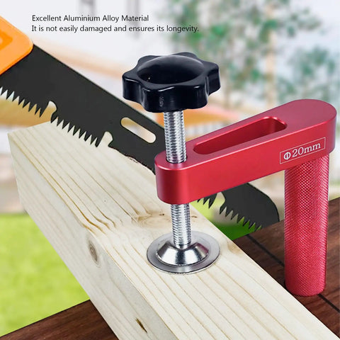 2 Pack 20mm Aluminum Bench Dog Clamps with saw and wood in background, durable red design, excellent for woodworking projects.
