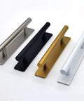 Four stainless steel and colored adhesive door handles in black, silver, gold, and white side by side on a white background.