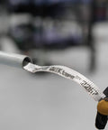 QWIKtape Pull Tape Go-To Multi Use Polyester Tape for threading and pulling wire, shown in use with conduit and glove