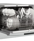 Total Game Changer Compact Countertop Dishwasher In Brushed Stainless Steel full of clean dishes, six place settings visible.