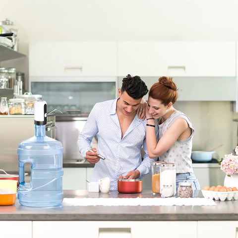 Couple in kitchen with Electric 5 Gallon Water Dispenser Pump Portable USB Rechargeable For Universal 2 To 5 Gallon Bottles Leak Proof Silicone Tube