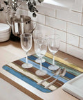 Blue Yellow Brown Wood Grain Dish Drying Mat For Kitchen Counter Absorbent Microfiber Quick Drying Machine Washable 16 By 18 Inches Abstract Art For Countertop with wine glasses and cutlery on top.