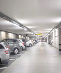 Easy Install T8 T10 T12 LED Tube Light 2-Foot 8W Replacement in a brightly lit parking garage ceiling.