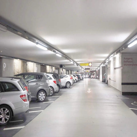 Easy Install T8 T10 T12 LED Tube Light 2-Foot 8W Replacement in a brightly lit parking garage ceiling.