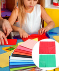 Child crafting with Ultra Thin Tissue Paper Sheets 66x50cm 40 Pack With High Light Transmission for wrapping and DIY projects.