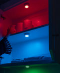 Color Changing LED Puck Lights Battery Operated With IR Remote 40 Lumens Under Cabinet Lighting illuminating shelves