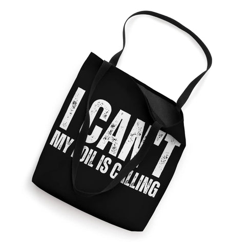 Black tote bag with text 'I Can't My Foil Is Calling' for wingfoiling enthusiasts, 16x16 inches with 14-inch handles, top view.