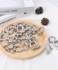 25 Pack One Quarter Inch 304 Stainless Steel D Ring Shackles Set on wooden platter for outdoor adventure and recovery