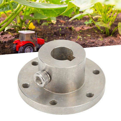 Heavy Duty 14mm Stainless Steel RC Shaft Coupling With Chain Slot And Flange Connector For RC Hobby Parts placed on soil near a toy tractor.