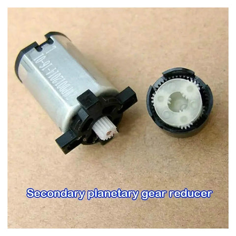Close-up of Planetary Gear Electronic Starter Motor, 420 RPM, 12mm Shaft, 5V/6V Compatible with exposed gear components on a surface