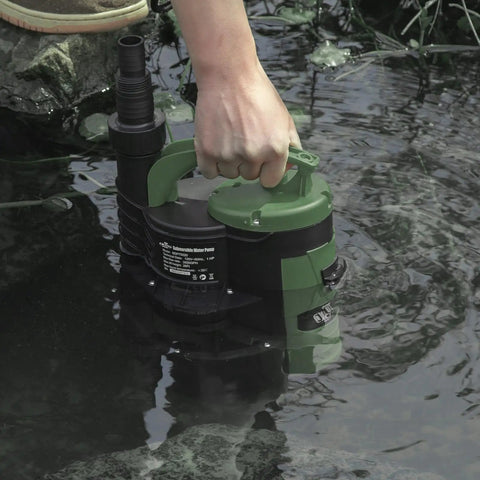1HP Submersible Sump Pump With 3500GPH for clean or dirty water, built-in float switch and carry handle in use near a pond.