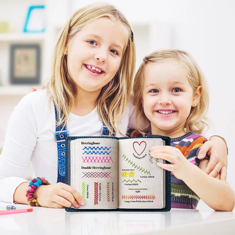 Two children holding DIY Embroidery Stitch Book Kit With 106 Illustrated Stitches, showing colorful patterns in a home setting.