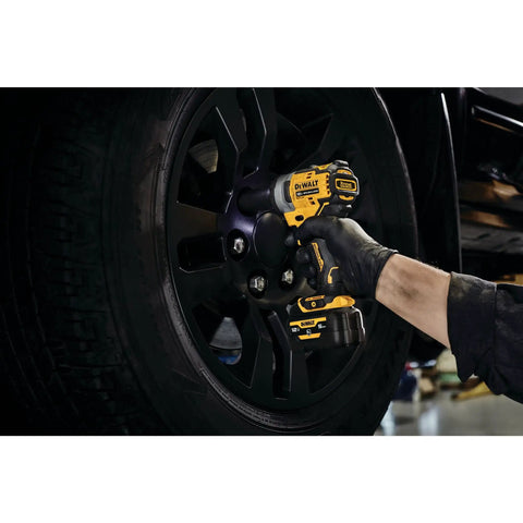 12V Max 3/8 Inch Cordless Impact Wrench Kit in use, removing tire bolts from a vehicle wheel, ergonomic design for easy handling.