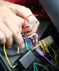 Hands installing European Type Classic Car Fuse Kit 60 Piece Set For Vintage Vehicles into car fuse box.