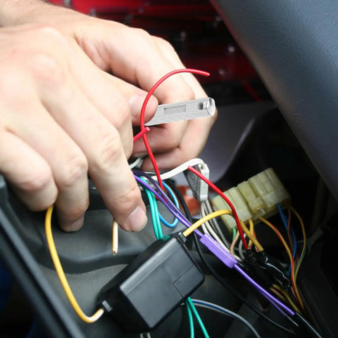 Hands installing European Type Classic Car Fuse Kit 60 Piece Set For Vintage Vehicles into car fuse box.