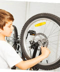 Child adjusting Heavy Duty Mechanical Disc Brake Kit With Front And Rear Rotors And Thick Pads For Mountain Bike on a bike.