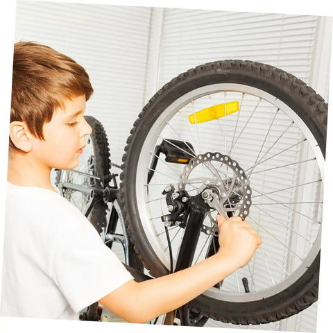 Child adjusting Heavy Duty Mechanical Disc Brake Kit With Front And Rear Rotors And Thick Pads For Mountain Bike on a bike.