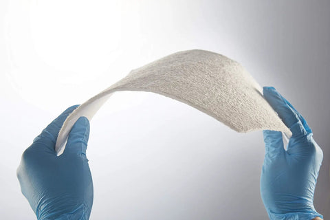 Hands holding Ultra Slim Aerogel Insulation Padding 9.8 Inch Square Pack Of 10 0.1 Inch Thick Heat Shield, showcasing flexibility.