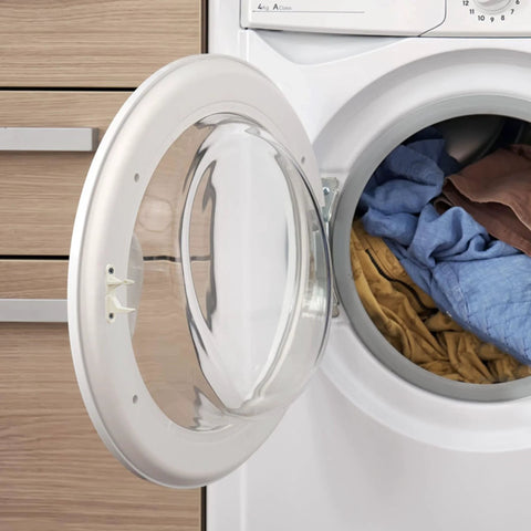 Front-loading washing machine with the door open and blue and brown laundry inside.