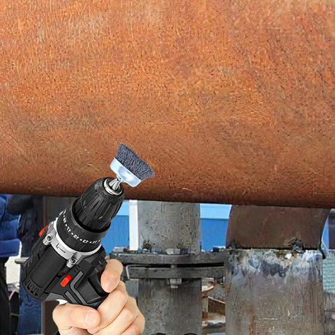 Hand using 18Piece Wire Wheel Cup Brush Set For Drills With One Quarter Inch Hex Shank on rusted metal pipe surface cleaning