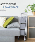 Three Step Stool With Anti Slip Pedals And Comfortable Handrail, Heavy Duty Portable Step Ladder stored next to a sofa